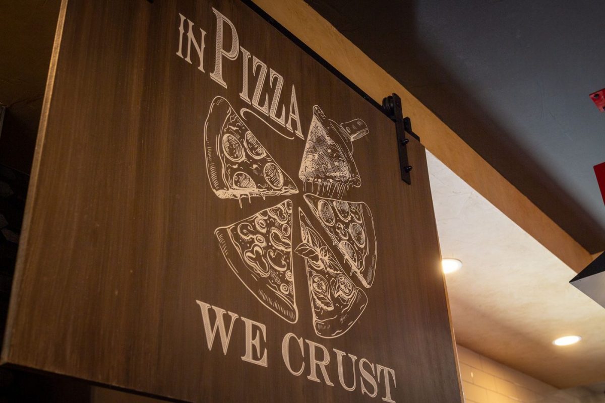 Sign saying in pizza we crust